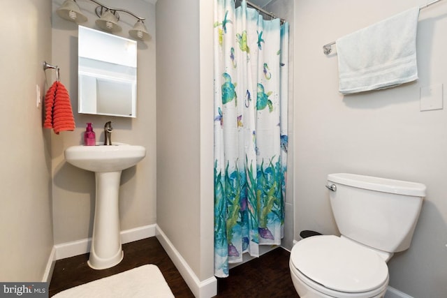 bathroom featuring hardwood / wood-style floors and toilet