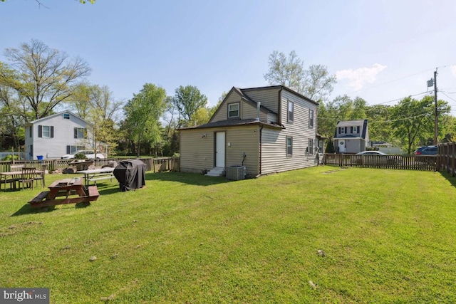 exterior space featuring cooling unit and a yard