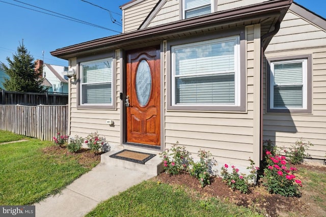 doorway to property featuring a yard