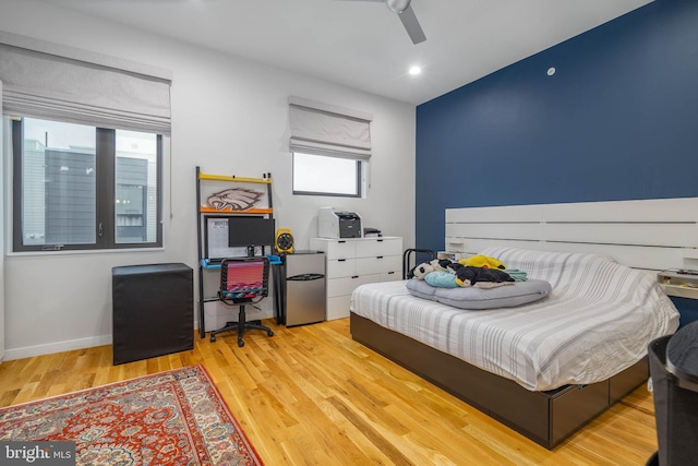 bedroom with ceiling fan and light wood-type flooring