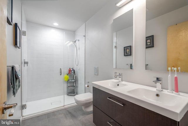 bathroom with tile patterned floors, walk in shower, double vanity, and toilet