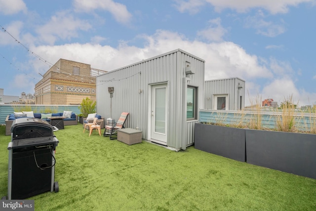 view of outbuilding with a lawn and an outdoor living space