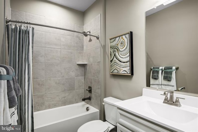 full bathroom featuring vanity, shower / bath combo with shower curtain, and toilet