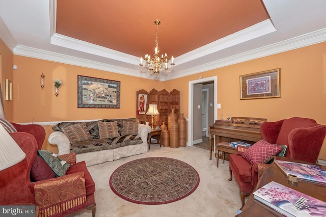 living room with a tray ceiling, a chandelier, light carpet, and ornamental molding