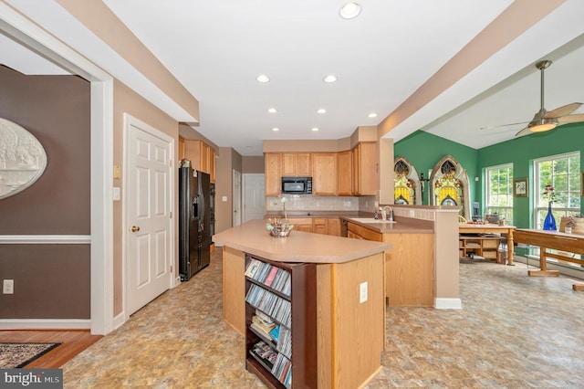 kitchen with black appliances, light brown cabinetry, backsplash, kitchen peninsula, and ceiling fan