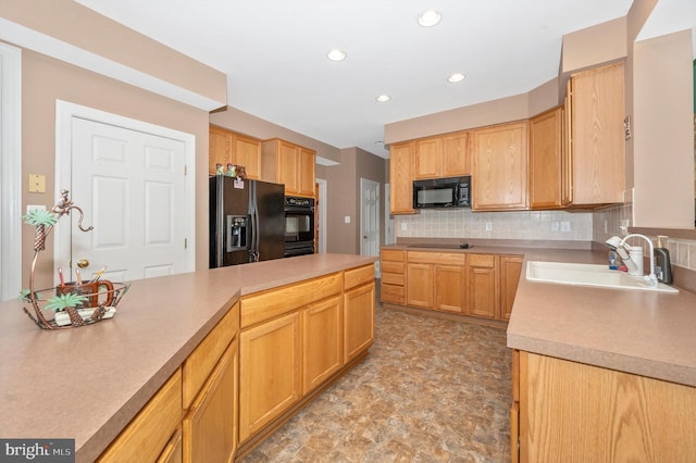 kitchen featuring black appliances, light brown cabinetry, sink, and tasteful backsplash