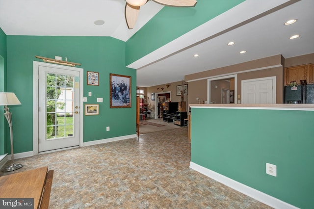 kitchen with lofted ceiling, ceiling fan, and black refrigerator with ice dispenser