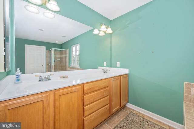 bathroom with tile patterned flooring, vanity, and a shower with shower door