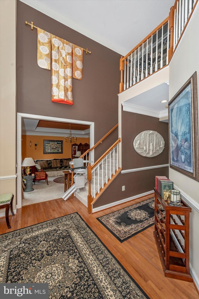 entrance foyer featuring hardwood / wood-style flooring and crown molding