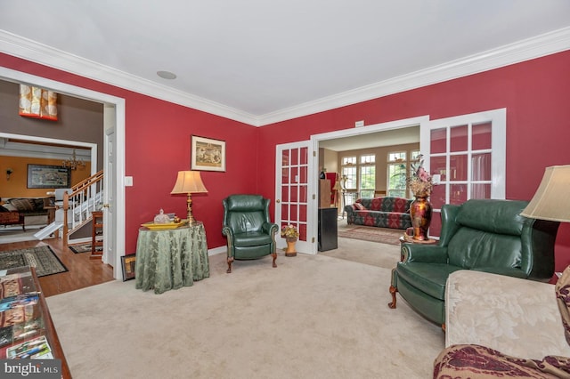 living area featuring crown molding, french doors, and wood-type flooring