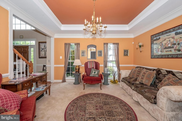 living room with a notable chandelier, a tray ceiling, crown molding, and light carpet