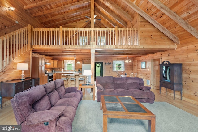 living room with high vaulted ceiling, light hardwood / wood-style floors, and wooden ceiling