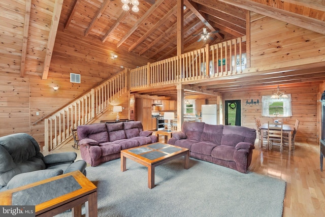 living room with hardwood / wood-style flooring, beamed ceiling, wooden walls, and wooden ceiling