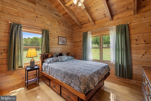 bedroom featuring light hardwood / wood-style flooring, wood ceiling, ceiling fan, wooden walls, and vaulted ceiling with beams