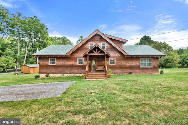 cabin with a front lawn