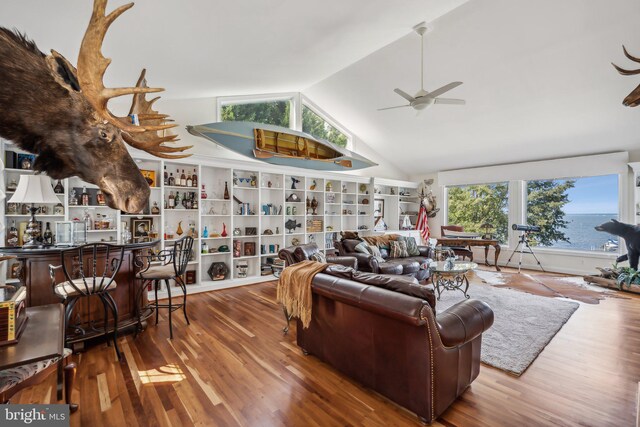 living room with vaulted ceiling and hardwood / wood-style flooring