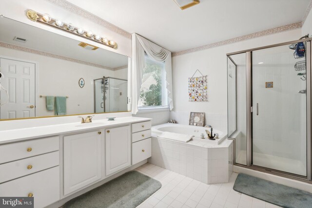 bathroom featuring shower with separate bathtub, tile patterned flooring, and vanity