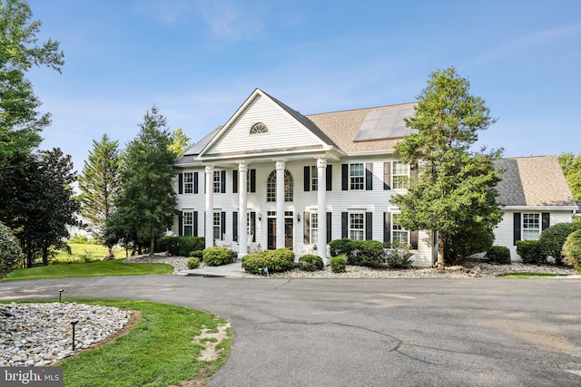 neoclassical home with solar panels