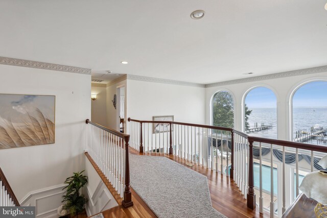 hall with ornamental molding and hardwood / wood-style flooring