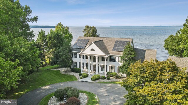 birds eye view of property with a water view