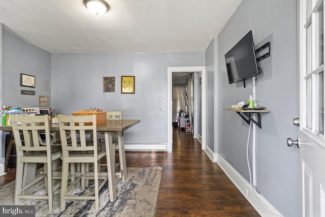 dining space with dark wood-type flooring