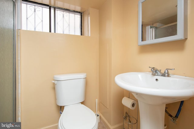 bathroom with walk in shower and toilet