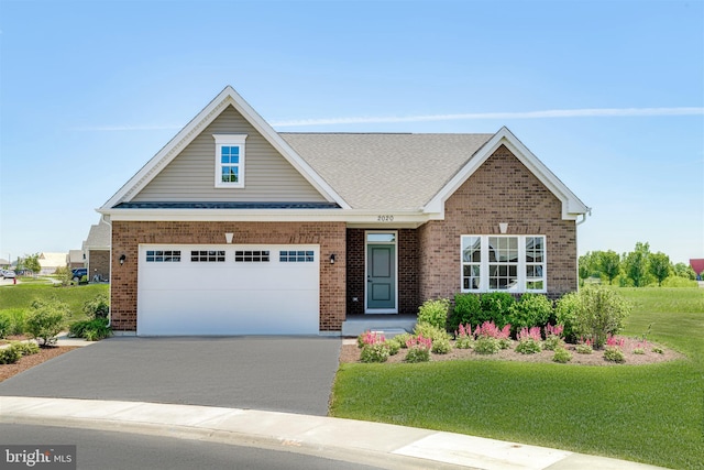 view of front of house with a front yard and a garage