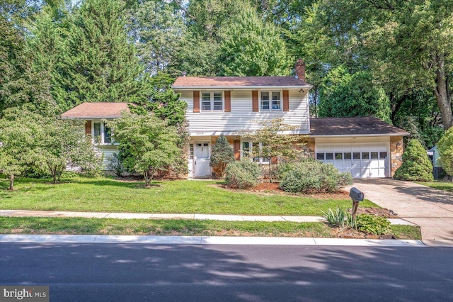 view of front of house with a garage and a front lawn