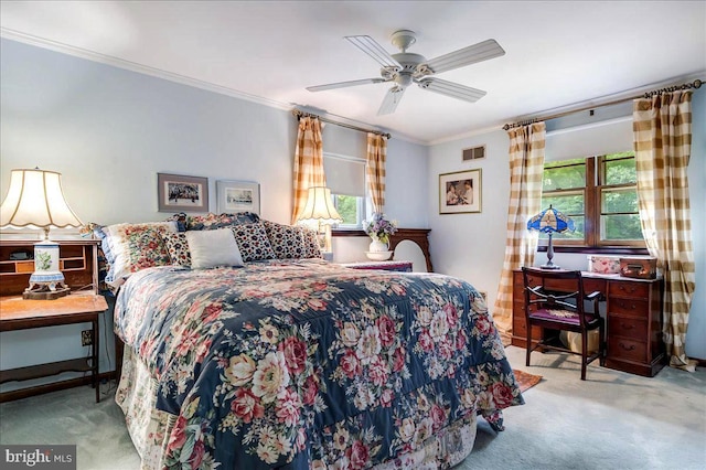 bedroom featuring light carpet, a ceiling fan, visible vents, and crown molding