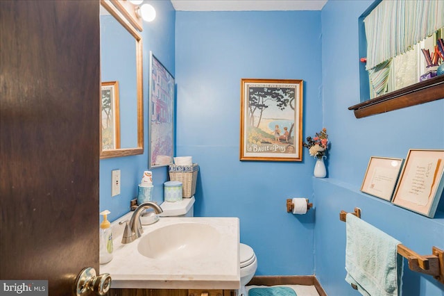 bathroom featuring toilet and vanity