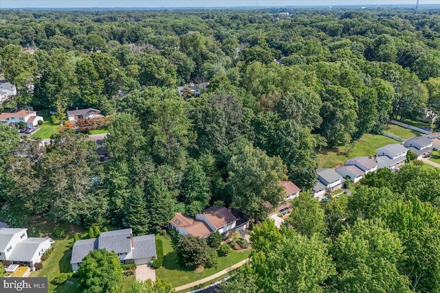 aerial view featuring a forest view and a residential view