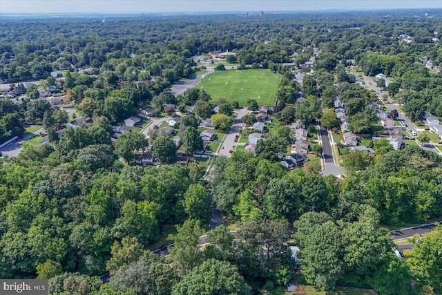 birds eye view of property featuring a forest view and a residential view