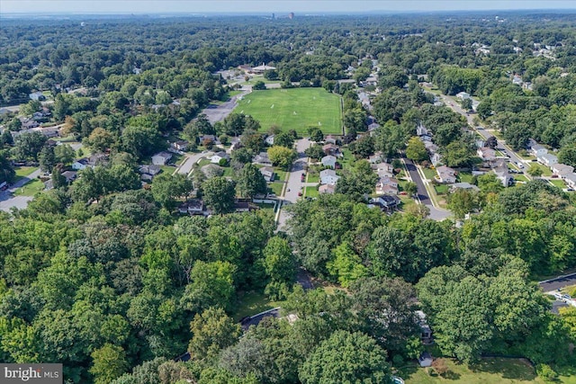 birds eye view of property featuring a forest view and a residential view