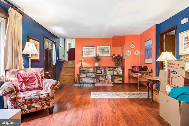 sitting room featuring stairway and wood finished floors