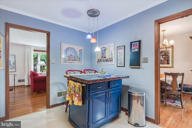 dining area with ornamental molding, visible vents, light wood-style floors, and a notable chandelier