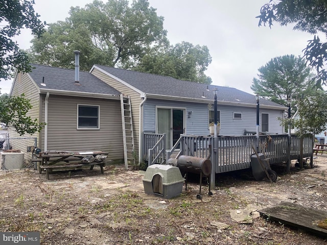 back of house featuring a wooden deck