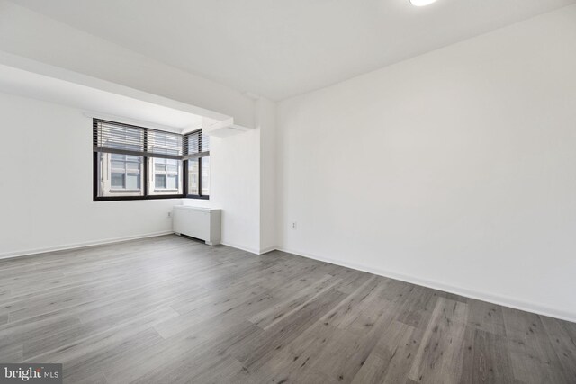 unfurnished room with wood-type flooring