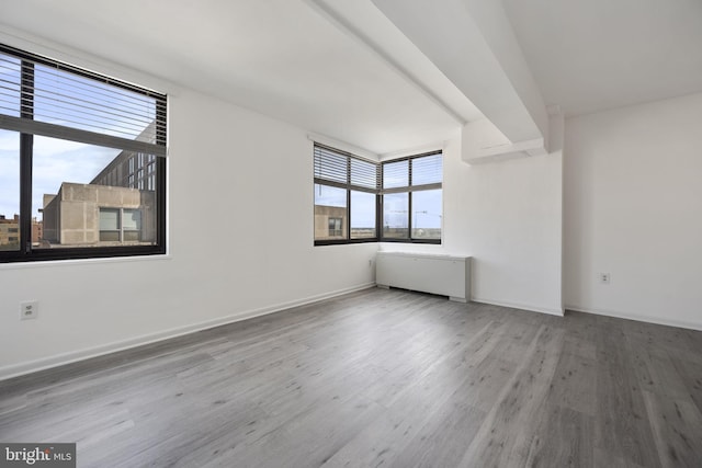 empty room with wood finished floors and baseboards