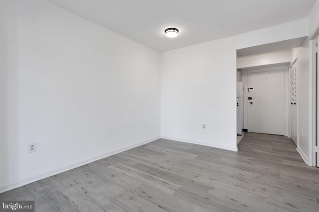 unfurnished room featuring wood finished floors and baseboards