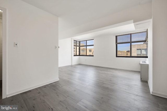 empty room featuring baseboards and wood finished floors