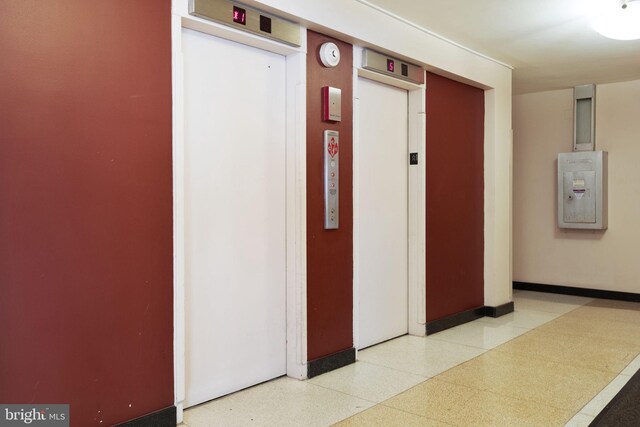 hall featuring elevator and speckled floor