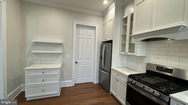 kitchen with white cabinetry, appliances with stainless steel finishes, dark wood-type flooring, and tasteful backsplash