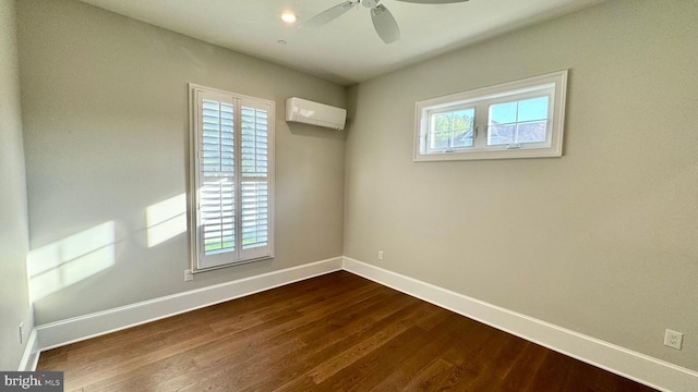 unfurnished room with ceiling fan, a wall unit AC, and dark hardwood / wood-style floors