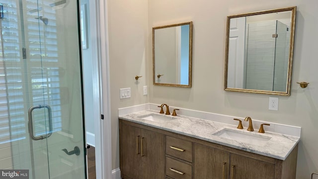 bathroom with vanity and a shower with shower door