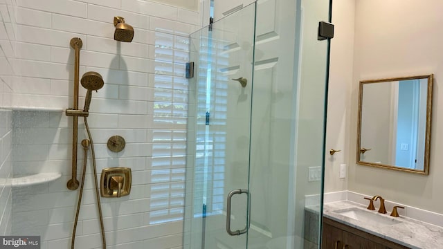 bathroom with vanity and a shower with shower door