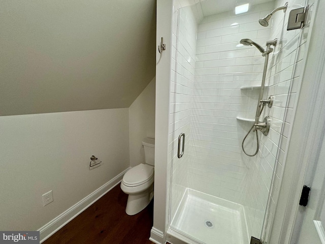 bathroom featuring an enclosed shower, hardwood / wood-style flooring, and toilet