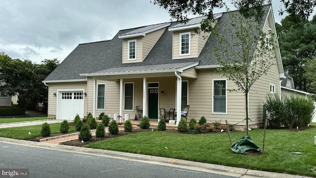 view of front of property featuring a garage, a front lawn, and a porch