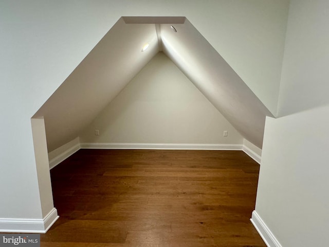 bonus room featuring dark hardwood / wood-style floors and vaulted ceiling