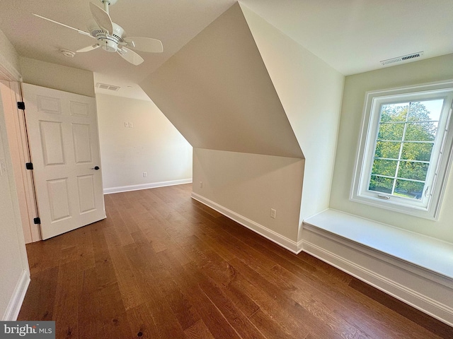 bonus room with dark hardwood / wood-style flooring, ceiling fan, and vaulted ceiling