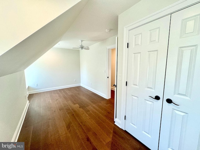 additional living space featuring dark wood-type flooring, ceiling fan, and vaulted ceiling